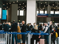 travellers wait in front of Condor check in counter at Duessedorf airport, Germany on March 26, 2021 as airlines adds more flights to cope w...