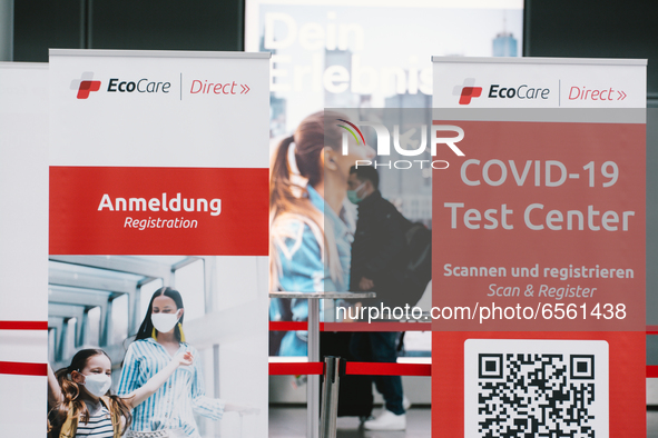 a man is seen walks pass a Coronavirus test center at Duessedorf airport, Germany on March 26, 2021 as airlines adds more flights to cope wi...