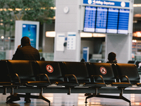 travellers waits in a chair at Duessedorf airport, Germany on March 26, 2021 as airlines adds more flights to cope with surge in demand (