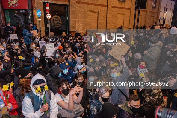 Protesters sit in front of the police cordon. Protesters gather in Bristol, UK  for the third time in a week on 26th March, 2021 to oppose t...