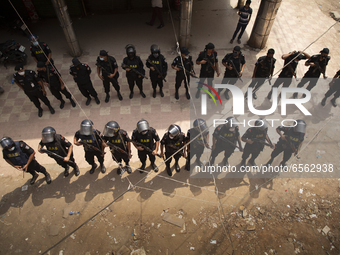 Police stand guard as activists from Islamist groups clash with the police during a protest against the visit of Indian Prime Minister Modi...