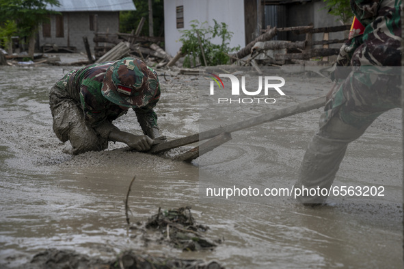 Soldiers cleaned up the remaining mud that hit a house in Beka Village, Marawola District, Sigi Regency, Central Sulawesi Province, Indonesi...