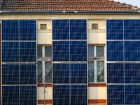 A number of solar collector panels are attached to the front wall of an old house in the center of Krakow, Poland on March 26, 2021. The rec...
