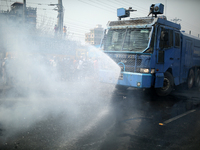 A police van sprays water to extinguish fire  at a highway after a clash with activists from Hefazat-e Islam during a nationwide strike foll...