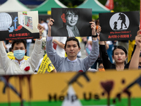 Group of people holding signs with Myanmar official Leader Aung San Suu Kyiduring a prayer's Anti Myanmar Coup protest in Taipei, Taiwan, on...