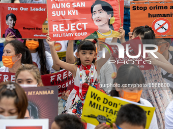 Young Girl holding a sign with the  portrait of Myanmar official Leader Aung San Suu Kyi during a prayer's Anti Myanmar Coup protest in Taip...