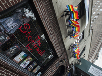 New Yorkers begin to arrive at the historic Stonewall Inn June 26, 2015 in the West Village after hearing of the ruling from the Supreme Cou...