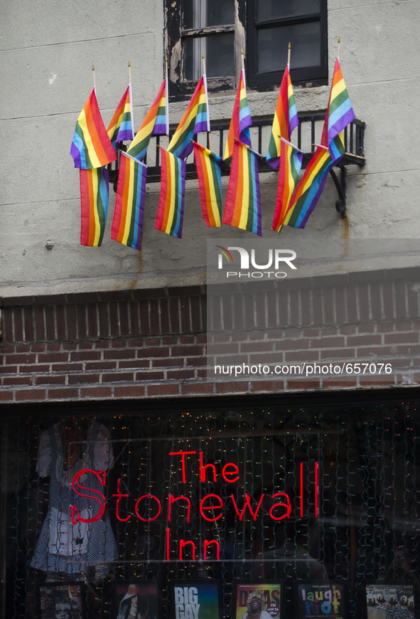 New Yorkers begin to arrive at the historic Stonewall Inn June 26, 2015 in the West Village after hearing of the ruling from the Supreme Cou...