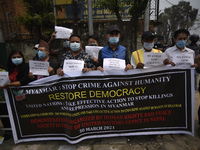 Nepalese Human Rights activists hold placards during protest against the Myanmar military coup in front of United Nations House at Pulchowk,...