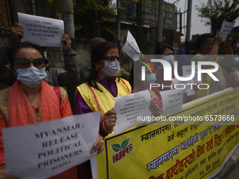 Nepalese Human Rights activists hold placards during protest against the Myanmar military coup in front of United Nations House at Pulchowk,...