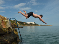 A swimmer jumps into the sea at the Vico bathing place, Hawk Cliff, in Dalkey, during COVID-19 level 5 lockdown. 
On Wednesday, March 31, 20...