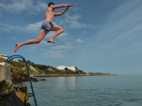 A swimmer jumps into the sea at the Vico bathing place, Hawk Cliff, in Dalkey, during COVID-19 level 5 lockdown. 
On Wednesday, March 31, 20...
