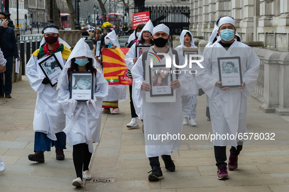 LONDON, UNITED KINGDOM - MARCH 31, 2021: Demonstrators wearing traditinal white Chinese funeral attire march through central London to the C...
