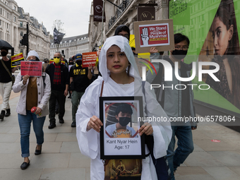 LONDON, UNITED KINGDOM - MARCH 31, 2021: Demonstrator holds a picture of a killed civilian during a march through central London to the Chin...