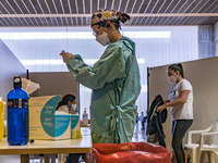 A health worker prepares an AstraZeneca vaccine syringe during the COVID-19 vaccination campaign in Santander, Spain. (
