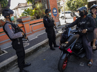 Armed Indonesian national police guards the gate of Bali Police Headquarter in Denpasar, Bali, Indonesia on April 1 2021. Indonesian police...
