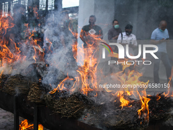 An Officer Prosecutor and Police are seen destroying evidence of marijuana by burning it in Lhokseumawe, on April 1, 2021, Aceh Province, In...