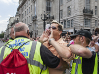 A contestator is held by security as people take part in the annual Pride in London Parade on June 27, 2015 in London, England. Pride in Lon...