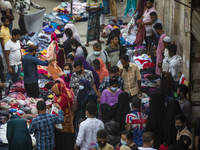 Residents gather to buy their needs at New Market amid the COVID-19 coronavirus emergency in Dhaka, Bangladesh on April 2, 2021. (