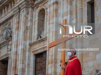 The Archbishop of Bogota, Monsignor Luis Jose Rueda, carries the holy cross during the representation of the Way of the Cross on Good Friday...