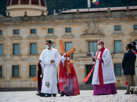 The Archbishop of Bogota, Monsignor Luis Jose Rueda, carries the holy cross during the representation of the Way of the Cross on Good Friday...