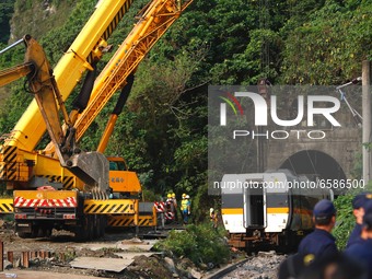 carriages of a train are being lifted and removed from a track after it derailed in a tunnel in Hualien on 2 April, in Hualien, Taiwan, 3 Ap...