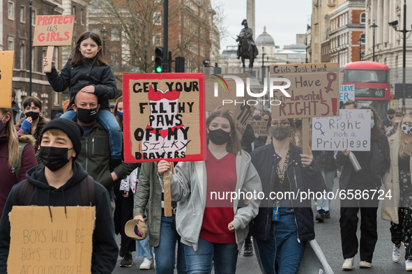LONDON, UNITED KINGDOM - APRIL 03, 2021: Demonstrators take part in a protest march through central London against violence towards women an...
