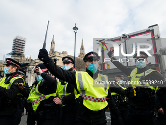 Police raise batons in London, Britain, 3 April 2021. Protests around the United Kingdom have been held in opposition to the Police, Crime,...