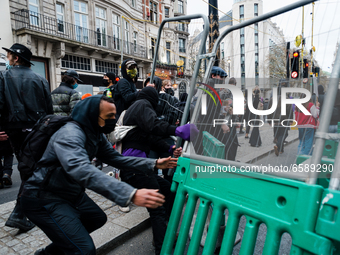 Protesters push down barriers in London, Britain, 3 April 2021. Protests around the United Kingdom have been held in opposition to the Polic...