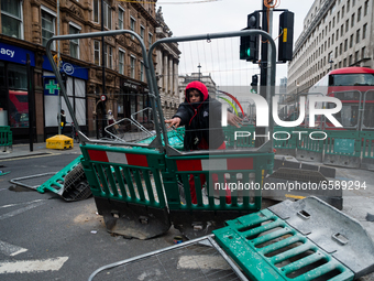 Protester pushes down barriers in London, Britain, 3 April 2021. Protests around the United Kingdom have been held in opposition to the Poli...