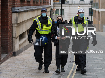 LONDON, UNITED KINGDOM - APRIL 03, 2021: Police officers arrest a demonstrator in central London after a protest against government’s Police...