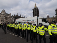 LONDON, UNITED KINGDOM - APRIL 03, 2021: Police officers make a cordon around a lorry outside Houses of Parliament in central London after a...