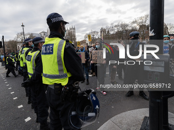 LONDON, UNITED KINGDOM - APRIL 03, 2021: Demonstrators stand behind a police cordon in Parliament Square after a protest against government’...