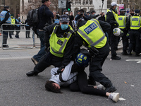 LONDON, UNITED KINGDOM - APRIL 03, 2021: Police officers arrest a female demonstrator in Parliament Square after a protest against governmen...
