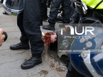 LONDON, UNITED KINGDOM - APRIL 03, 2021: Police officers arrest a demonstrator in Trafalgar Square after a protest against government’s Poli...
