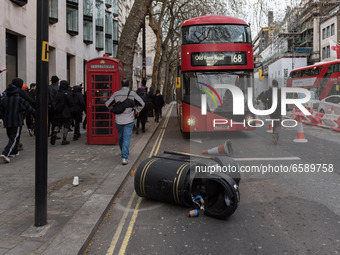LONDON, UNITED KINGDOM - APRIL 03, 2021: A rubbish bin is lying on the road in central London after a protest against government’s Police, C...