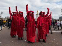 LONDON, UNITED KINGDOM - APRIL 03, 2021: Extinction Rebellion's Red Brigade take part in a protest march through central London against gove...
