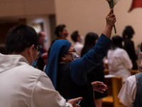 A nun carries out the traditional blessing of the faithful during the easter mass at Our Lady of Mount Carmel in Wanchai. (