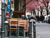 tables and chairs are seen stacking on the street as early cherry blossoms are seen in historical district in Bonn, Germany on April 04, 202...