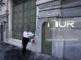 Pensioner outside the closed National Bank of Greece headquarters in Athens on June 29, 2015. Greece weighed drastic banking restrictions to...