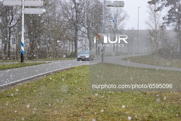 Car on the road during the snow. Snowfall in the Netherlands makes the first 
