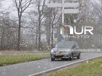 Car on the road during the snow. Snowfall in the Netherlands makes the first 