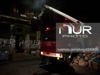 Firefighters put out a fire in a building in the center of Athens close to Vathi's square on April 5, 2021. 
 (