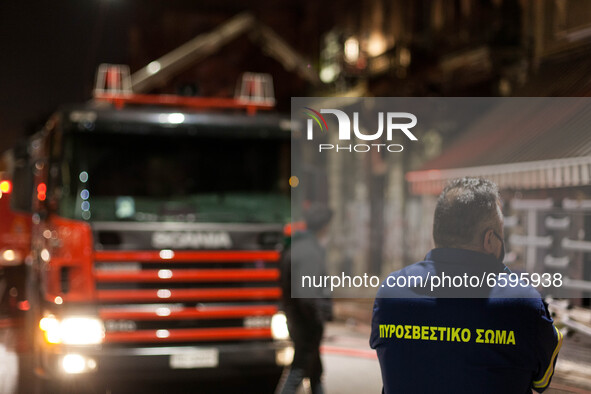 Firefighters put out a fire in a building in the center of Athens close to Vathi's square on April 5, 2021. 
 