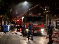 Firefighters put out a fire in a building in the center of Athens close to Vathi's square on April 5, 2021. 
 (