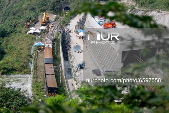 Views of the damaged train carriages being lifted and removed from tracks after it derailed in a tunnel in Hualien, Taiwan, 3 April 2021, le...