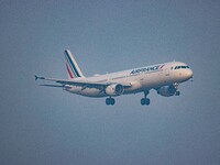 Air France Airbus A321 aircraft as seen flying on final approach for landing at Amsterdam Schiphol Airport AMS EHAM during a misty weather m...