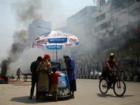 An ice-cream vendor sales ice cream while Construction workers working on a road that creates toxic smoke as they burn animal leather in a r...