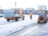 Service vehicles cleaning the snow from the roads. The Netherlands wakes up snow covered after an intense morning snowfall, a bizzar event f...