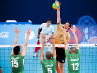 Todor ALEKSIEV (15),Svetoslav GOTSEV (5) and  Jani JELIAZKOV (12)  of Bulgaria are jumping on the net on the hit of Christian FROMM (1) of G...